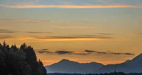 Time lapse of colorful clouds moving over Alps mountains Stock Footage 134394445