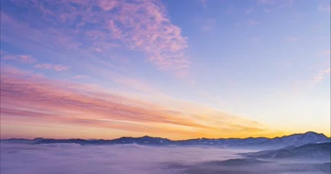 Time lapse of colorful clouds moving over alpine valley Video stock 167732695