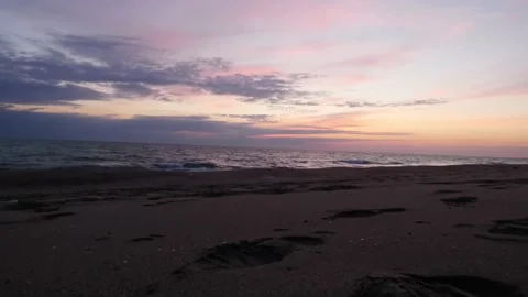 Time lapse colorful dark clouds at sunset over ocean or sea. Beautiful light of Stock Footage 226622648