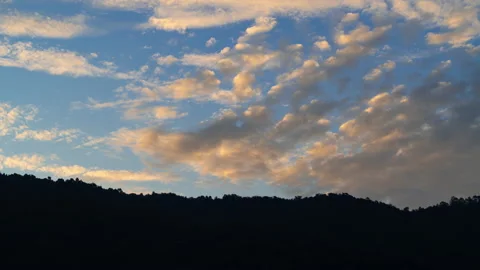 Time lapse of colorful dramatic moving clouds during morning sunrise Stock Footage 219543910