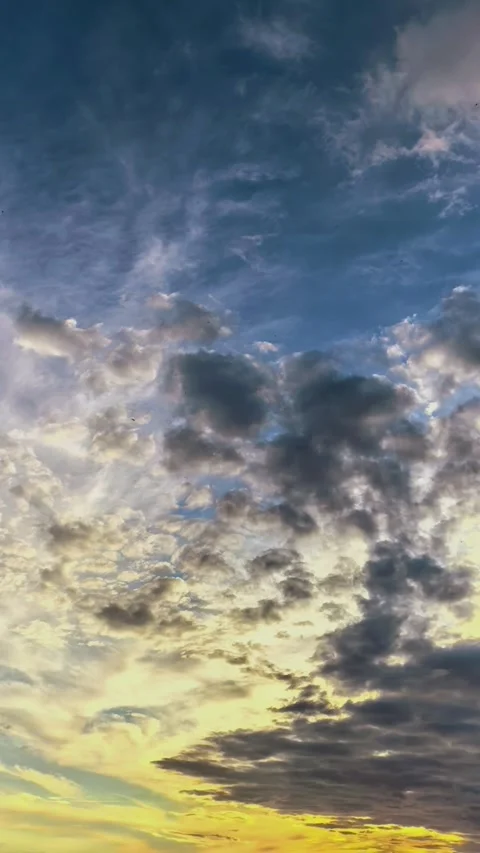 Time lapse of colorful evening clouds moving across a dramatic sky, atmospheric Stock Footage 339642179