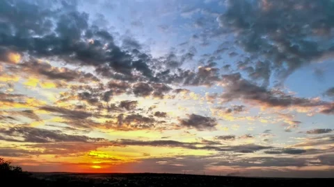 Time lapse of a colorful evening sky with glowing sunset and layered clouds Stock Footage 345592540