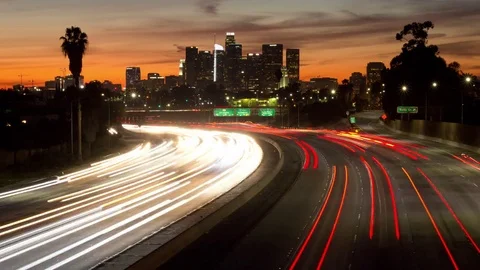 Time lapse of colorful sunset clouds, traffic and the Los Angeles skyline Stock Footage 83278047