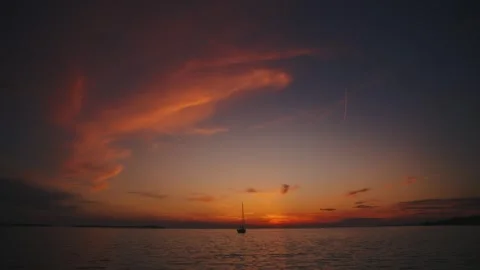 Time lapse of colorful sunset sky over calm Adriatic Sea horizon with distant Stock Footage 343895261