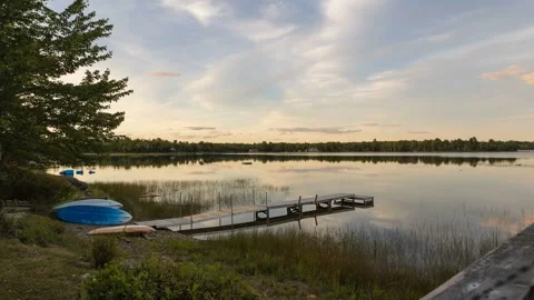 Time lapse of a colourful sunset reflecting in a lake Stock Footage 317786525