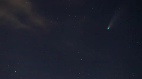 Time lapse of Comet NEOWISE or C/2020 F3 (NEOWISE) with cloud in the night sky. Stock Footage 135982797