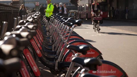 Time lapse of commuters taking hire bicycles from docking station terminal Stock Footage 64655684