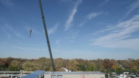 Time-lapse of Construction Site Large Industrial Crane Working on building roof Stock Footage 144627271
