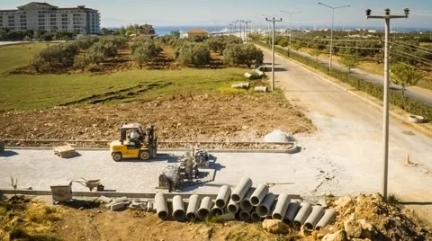 Time lapse of construction workers and small loader fixing the pavestone on the Stock Footage 49933566