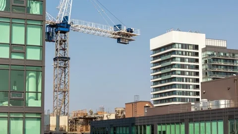 Time lapse of construction workers and a crane on the roof of a new building Stock Footage 159801221