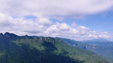 Time Lapse of Continuous Green Mountain Wide Valley Sky Cloud Cluster Stock Footage 337942743