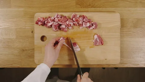 TIME-LAPSE: Cook cutting a pork into slices on a board - Top view Stock Footage 130260512