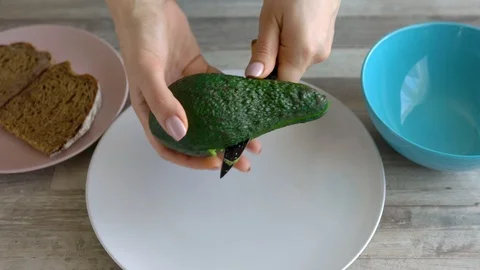 Time lapse of cooking avocado toast - cut the avocado and take out the pulp Stock Footage 105608853