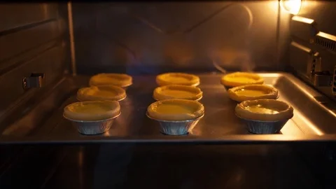 Time-lapse : cooking custard egg tarts at oven Stock Footage 74248512