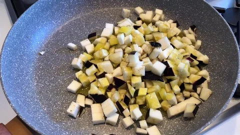 Time lapse of cooking eggplants or aubergines pieces with olive oil in a pot. Stock Footage 85718273