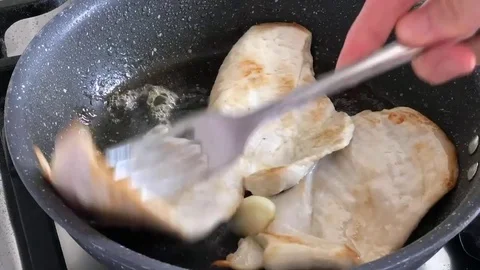 Time lapse of cooking slice of chicken with olive oil and thyme in a pot. Stock-Footage 79853703