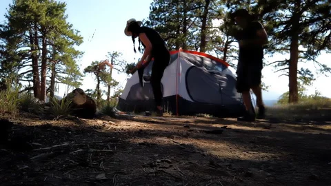 Time lapse of a couple assembling and raising a tent in the mountains Stock Footage 138477214
