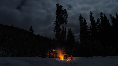 Time lapse of couple camping at night in wilderness in winte with campfire Stock Footage 105208480