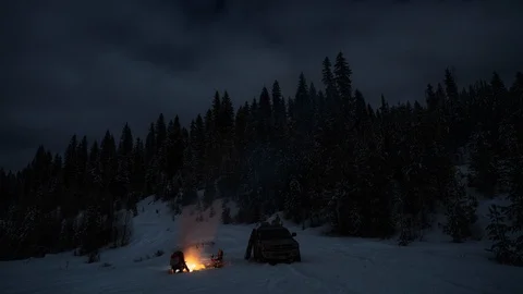 Time lapse of couple camping at night in wilderness in winte with campfire Stock Footage 105212058