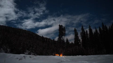 Time lapse of couple camping at night in wilderness in winter with campfire Stock Footage 105212737