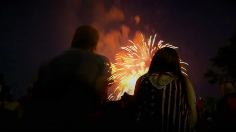 Time Lapse of couple watching fireworks display with patriotic shirt Stock Footage 66434916