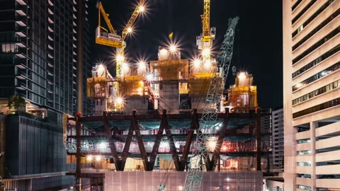 Time-lapse of crane and construction worker in under construction site Stock Footage 144211623