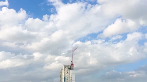 Time-lapse of the crane moving at construction building site with white cloud Stock Footage 90987707