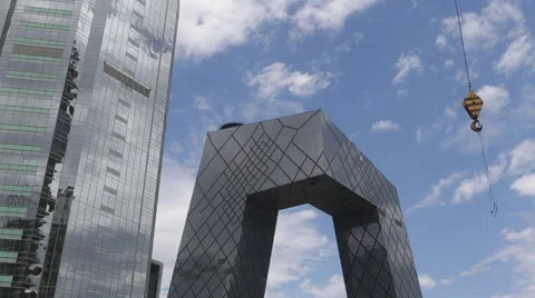 Time Lapse of a crane working as white clouds past CCTV tower Stock Footage 51140613