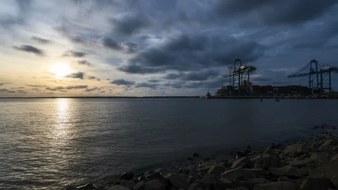 Time lapse of Cranes lifting containers onto cargo ship at North Port Stock Footage 101067768