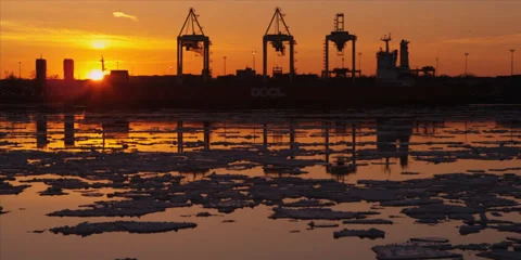 Time lapse of cranes unload ship at commercial port during iceberg sunset 2 Stock-Footage 37661126