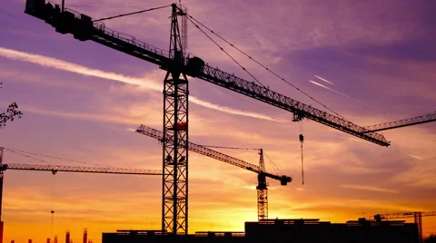 Time lapse  cranes working in construction site at dusk, zoom out stock footage Stock Footage 55431350