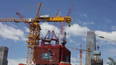 Time Lapse of cranes working while white clouds flying over a construction site Stock Footage 51140357