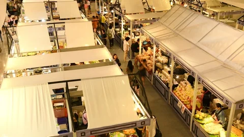 Time lapse of crowd walking and buying goods in the market stall . Stock Footage 125949777