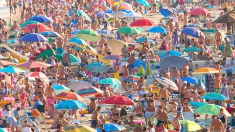 Time lapse Crowded Beach Top Side View. Huge Crowd on Coastline in Hot Summer Stock Footage 141399109