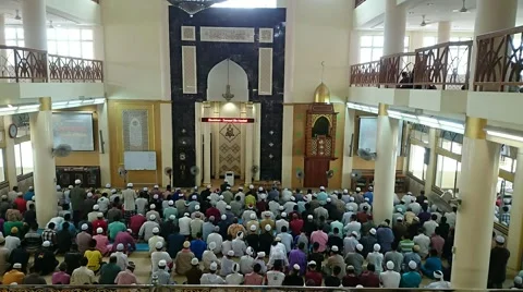 Time lapse of crowds of muslim men performing prayer or salat and leaving mosque Stock Footage 41677368