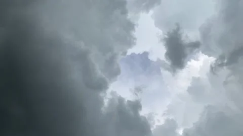 Time lapse of cumulus clouds with dark cloud enveloping Stock Footage 164214018
