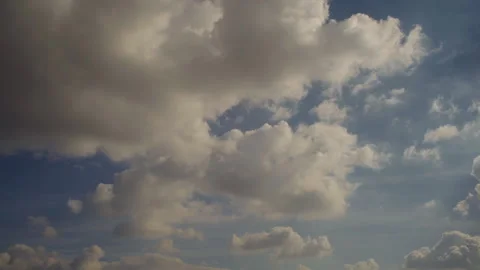 Time lapse, cumulus clouds moving rapidly into the distance across blue sky Stock Footage 279174044