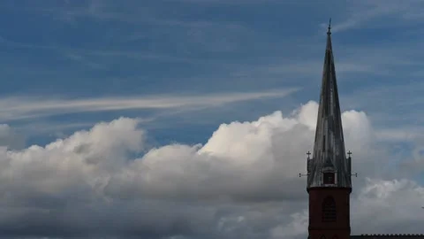 Time-lapse of cumulus clouds passing church steeple Stock Footage 159922055