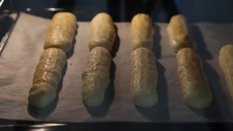 Time-lapse. custard cakes or eclairs baking process in the oven Stock Footage 150099690