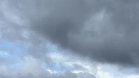 Time-lapse of dark and light clouds with sky opening Stock Footage 320163323