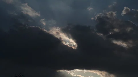Time lapse of dark backlit clouds in motion, with a blue sky background Stock Footage 273267275
