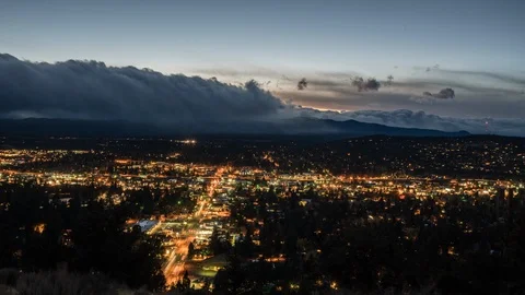 Time-lapse of dark clouds moving over the cityscape at night Stock Footage 87475679