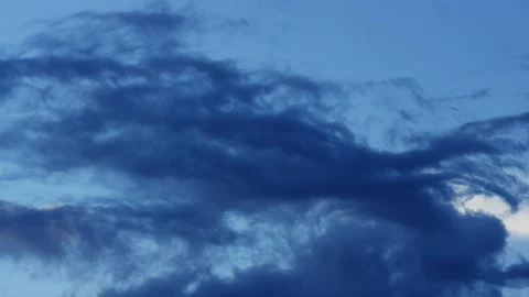 Time-lapse of dark clouds moving with moody blue sky  Stock Footage 102242378
