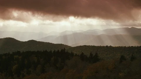 Time-lapse of dark clouds moving over the mountain ranges and forest Stock Footage 103395524