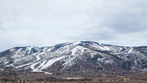 Time-lapse of dark clouds moving in the sky over snow clad mountains Stock Footage 116786479