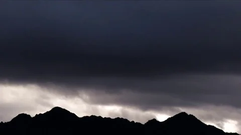 Time lapse of dark clouds over mountain range Stock Footage 72987656