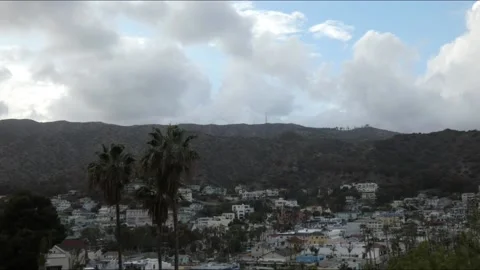 Time lapse dark clouds over small town day turns to night. Stock Footage 174365952