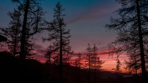 Time lapse of dark clouds rolling over the trees at sunset Stock Footage 77815127
