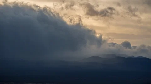 Time-lapse of dark clouds rolling in the sunset sky Stock Footage 87476144