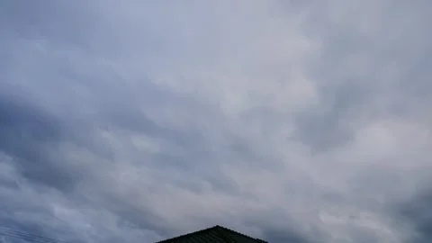 Time-lapse of dark clouds spreading across the evening sky turning into night Stock Footage 335818894
